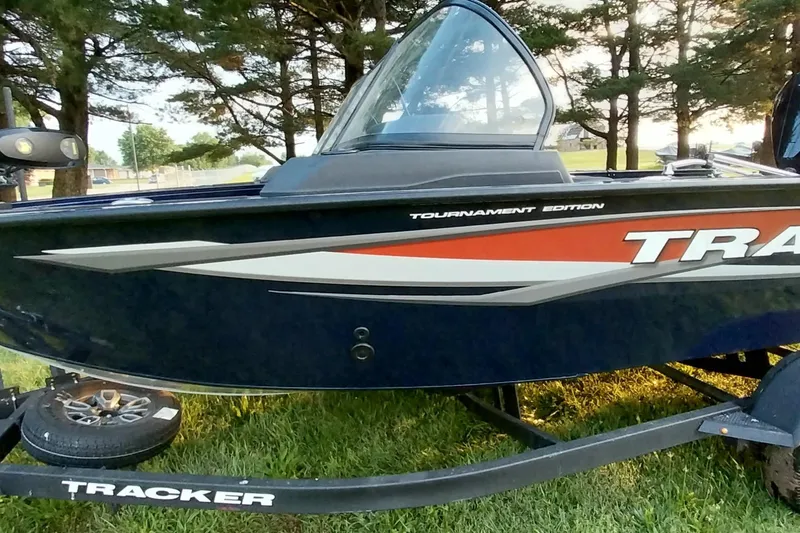 Slide: The Image of 2025 Tracker Targa V-19 WT boat on trailer, surrounded by trees. - 32