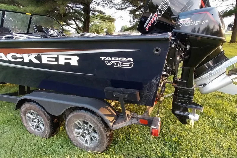 Slide: The Image of 2025 Tracker Targa V-19 WT boat on trailer, parked on grass. - 33