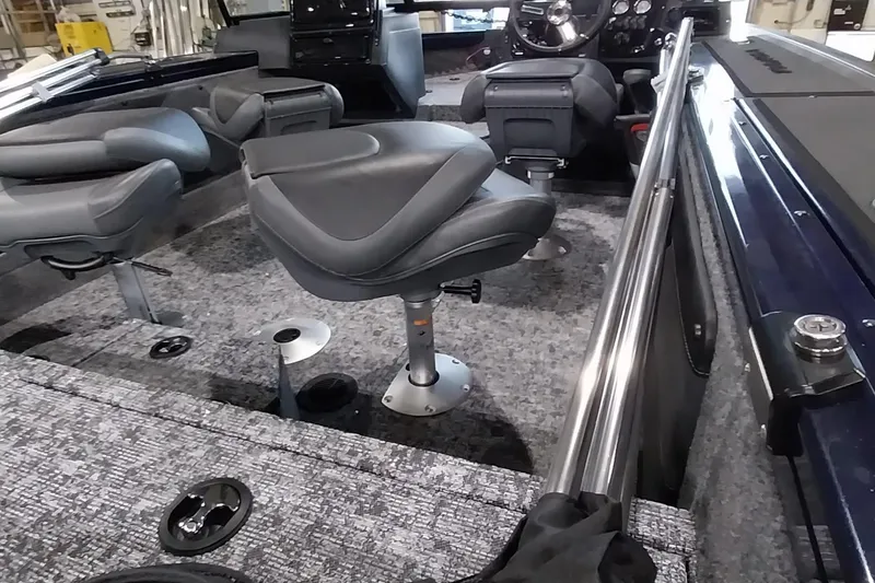 Slide: The Image of 2025 Tracker Targa V-19 WT boat interior with gray seating and modern dashboard. - 36