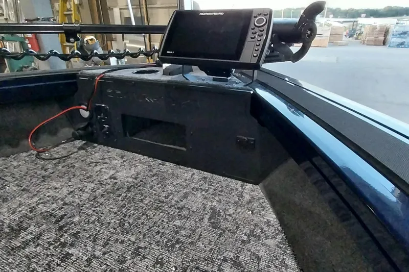 Slide: The Image of 2025 Tracker Targa V-19 WT boat interior with fish finder and carpeted deck. - 4