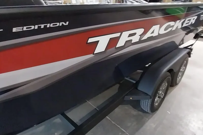 Slide: The Image of 2025 Tracker Targa V-19 WT boat with bold graphics on a trailer. - 9