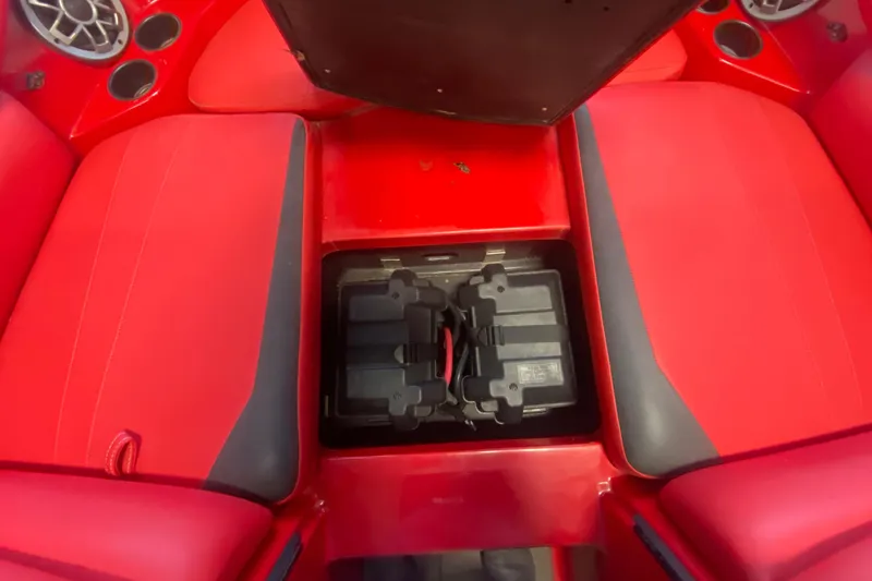 Slide: The Image of Red interior of a 2019 Axis A24 boat showing battery compartment. - 11
