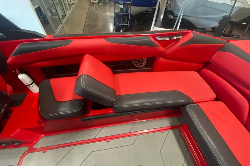 Slide: The Image of 2019 Axis A24 boat interior with red and black seating, featuring a fire extinguisher. - 16