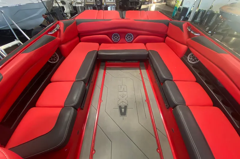 Slide: The Image of 2019 Axis A24 boat interior with red and black seating, featuring built-in speakers. - 19