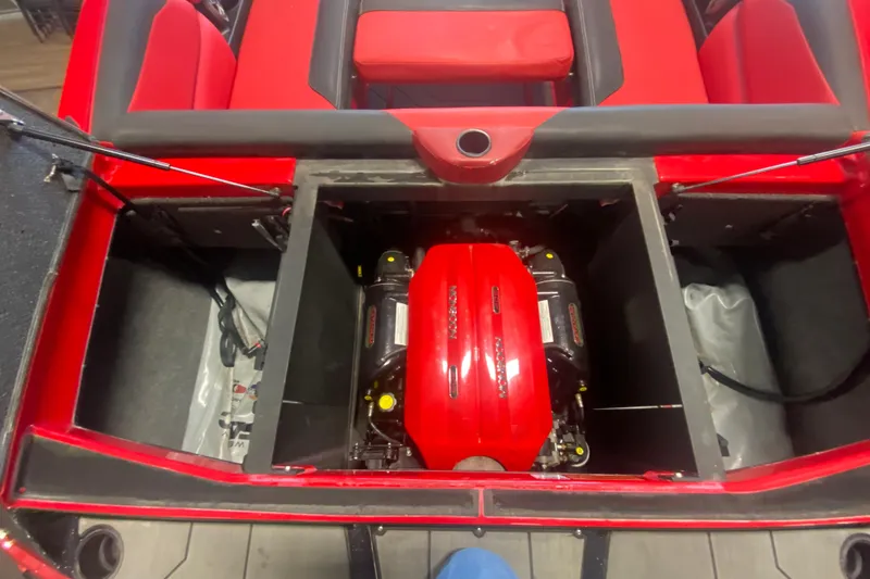 Slide: The Image of 2019 Axis A24 boat engine compartment with red upholstery and visible engine components. - 22