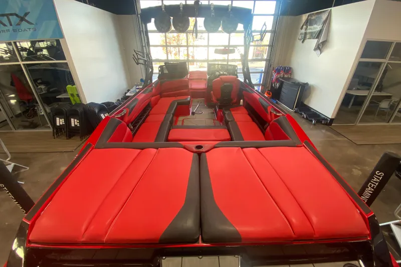 Slide: The Image of 2019 Axis A24 boat interior with red and black seating in showroom. - 23