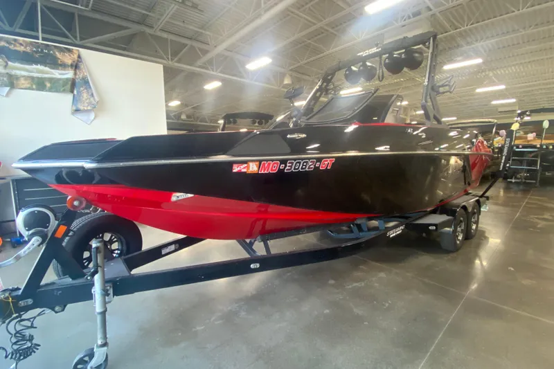 Slide: The Image of 2019 Axis A24 boat in showroom, black and red design on trailer. - 25