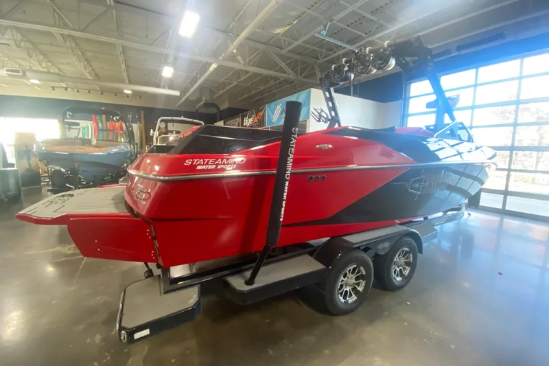 Slide: The Image of 2019 Axis A24 boat in showroom, red and black design, on trailer. - 29