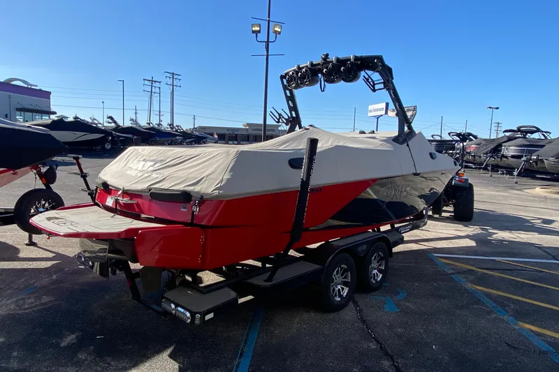 Slide: The Image of 2019 Axis A24 boat with cover on trailer in parking lot. - 35