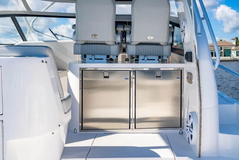 Slide: The Image of 2022 Intrepid 477 Evolution boat interior with sleek seating and stainless steel storage. - 10