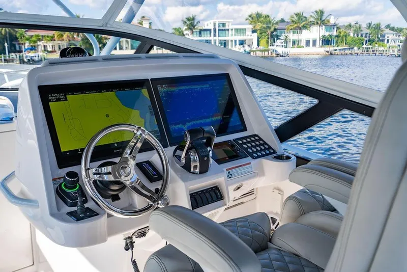 Slide: The Image of Helm of 2022 Intrepid 477 Evolution yacht with advanced navigation displays. - 11
