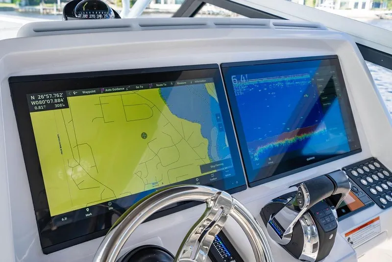 Slide: The Image of 2022 Intrepid 477 Evolution helm with dual navigation screens and steering wheel. - 13