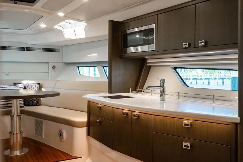 Slide: The Image of Luxurious interior of 2022 Intrepid 477 Evolution yacht with modern kitchen and seating area. - 17