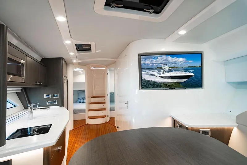 Slide: The Image of Luxurious interior of 2022 Intrepid 477 Evolution yacht with modern kitchen and TV display. - 18