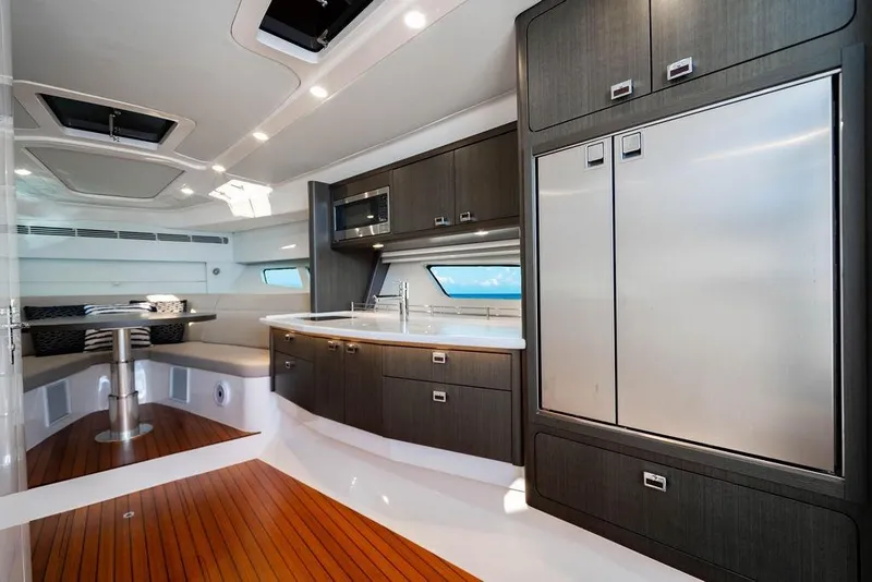 Slide: The Image of Luxurious interior of 2022 Intrepid 477 Evolution yacht with modern kitchen and seating area. - 19