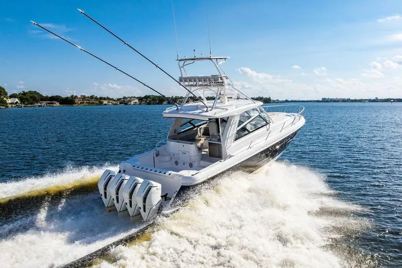 Slide: The Image of 2022 Intrepid 477 Evolution boat cruising on a sunny day, showcasing powerful engines. - 2