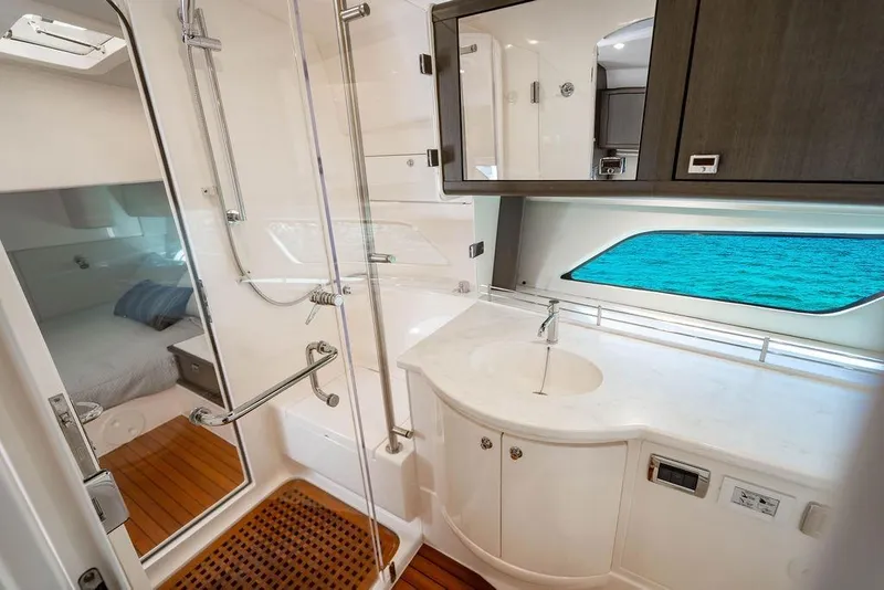 Slide: The Image of Luxurious bathroom interior of 2022 Intrepid 477 Evolution yacht with ocean view. - 22