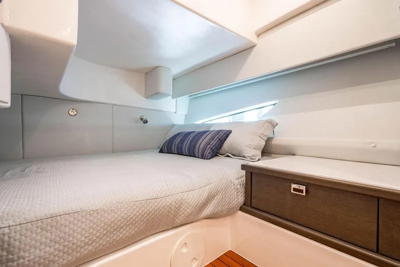 Slide: The Image of Luxurious cabin interior of 2022 Intrepid 477 Evolution yacht with cozy bedding. - 23