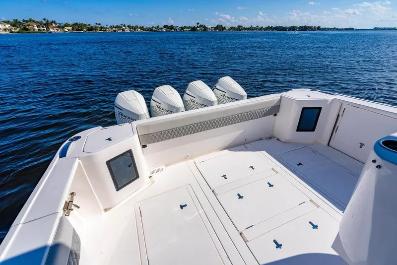 Slide: The Image of 2022 Intrepid 477 Evolution boat with quad engines on a calm blue sea. - 6