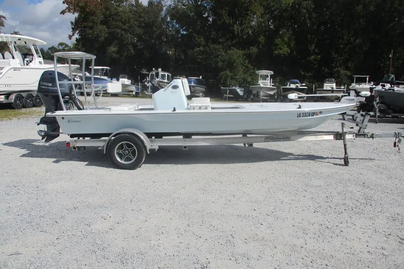 The Image of 2022 Brackish 19 boat on trailer, parked outdoors with other boats in background. - 0