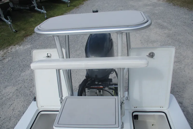 Slide: The Image of 2022 Brackish 19 boat with outboard motor and storage compartments. - 12