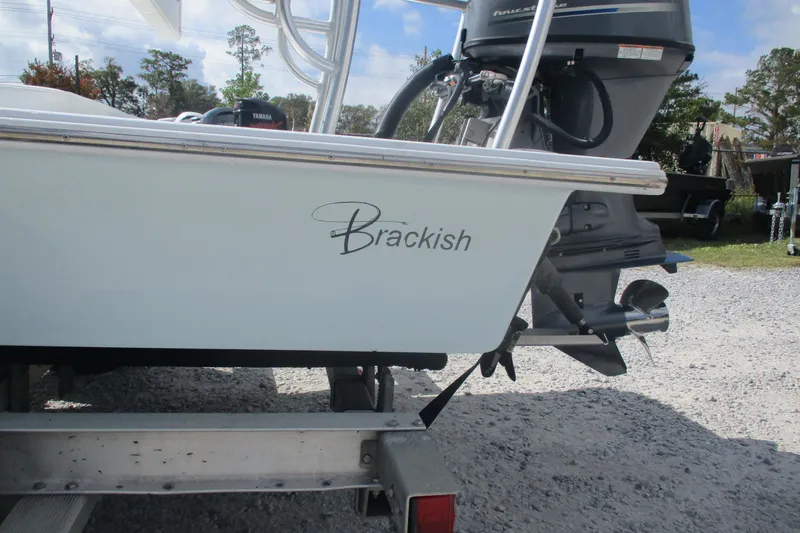 Slide: The Image of 2022 Brackish 19 boat with Yamaha outboard motor on trailer. - 2