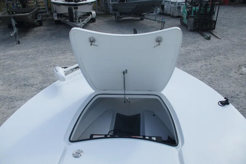 Slide: The Image of Open storage compartment on 2022 Brackish 19 boat, surrounded by other boats. - 6