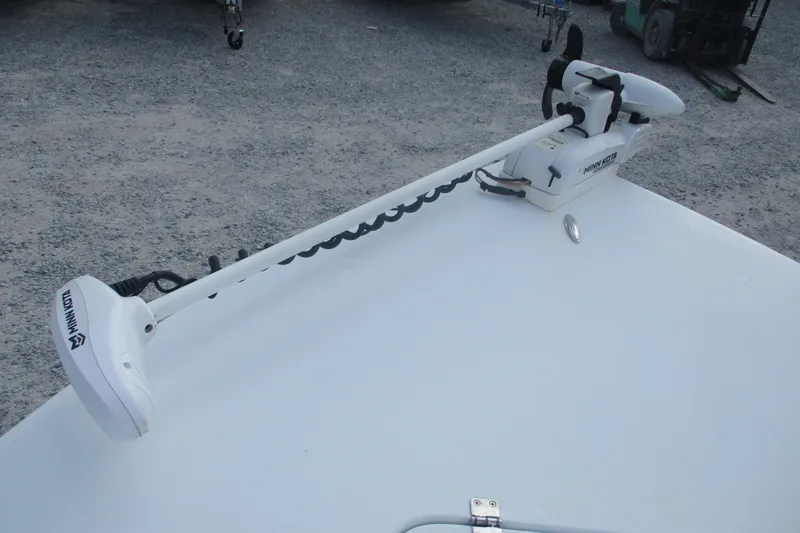 Slide: The Image of Minn Kota trolling motor on 2022 Brackish 19 boat, parked on gravel surface. - 7