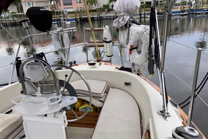 Slide: The Image of Cockpit of 1990 Pacific Seacraft 34 Voyager sailboat with steering wheel and safety equipment. - 10