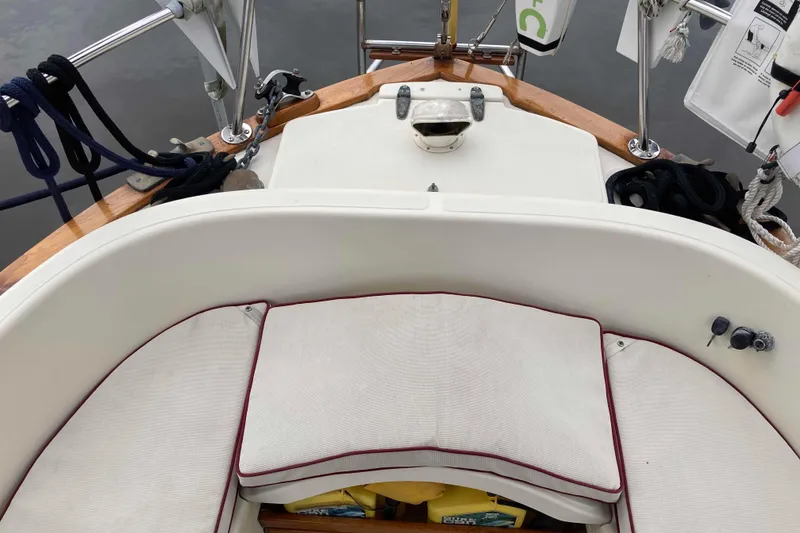 Slide: The Image of Cockpit of 1990 Pacific Seacraft 34 Voyager sailboat with cushioned seating and nautical equipment. - 12
