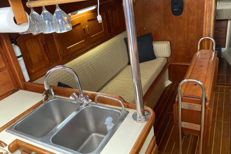 Slide: The Image of Interior of 1990 Pacific Seacraft 34 Voyager sailboat with kitchen sink and seating area. - 15