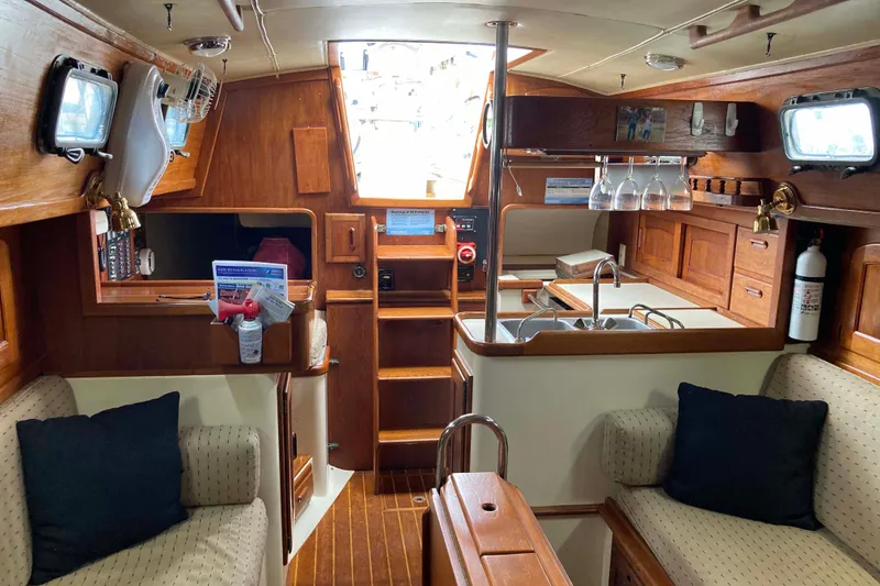 Slide: The Image of Cozy interior of 1990 Pacific Seacraft 34 Voyager sailboat with wood finish and seating. - 17
