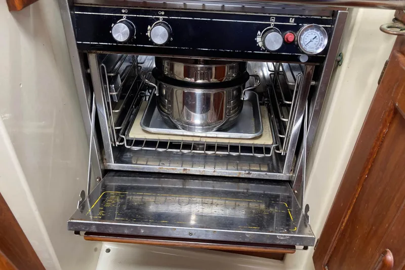 Slide: The Image of Stainless steel oven with pots inside on a 1990 Pacific Seacraft 34 Voyager. - 20