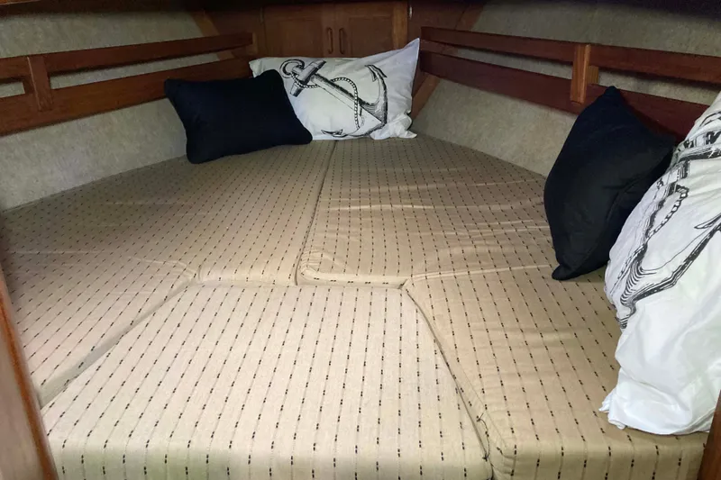 Slide: The Image of Cozy cabin bed in 1990 Pacific Seacraft 34 Voyager sailboat with anchor-themed pillows. - 26
