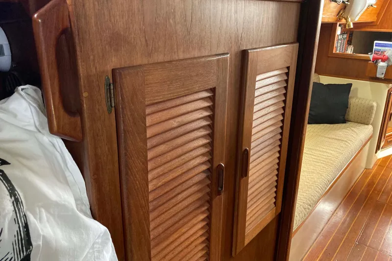 Slide: The Image of Interior of 1990 Pacific Seacraft 34 Voyager with wooden cabinetry and seating area. - 27