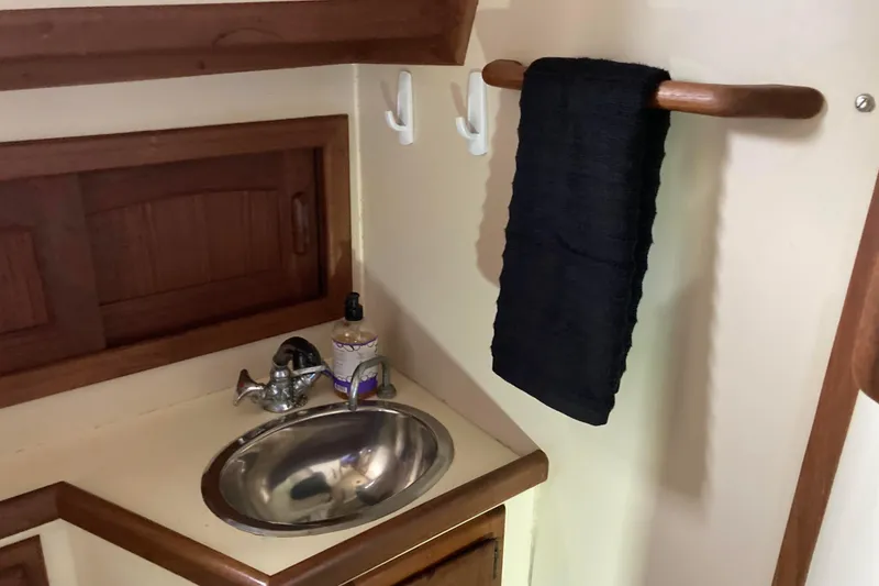 Slide: The Image of Compact bathroom sink area in a 1990 Pacific Seacraft 34 Voyager yacht. - 28
