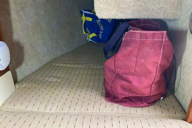 Slide: The Image of Interior cabin storage of 1990 Pacific Seacraft 34 Voyager with bags and life jackets. - 30