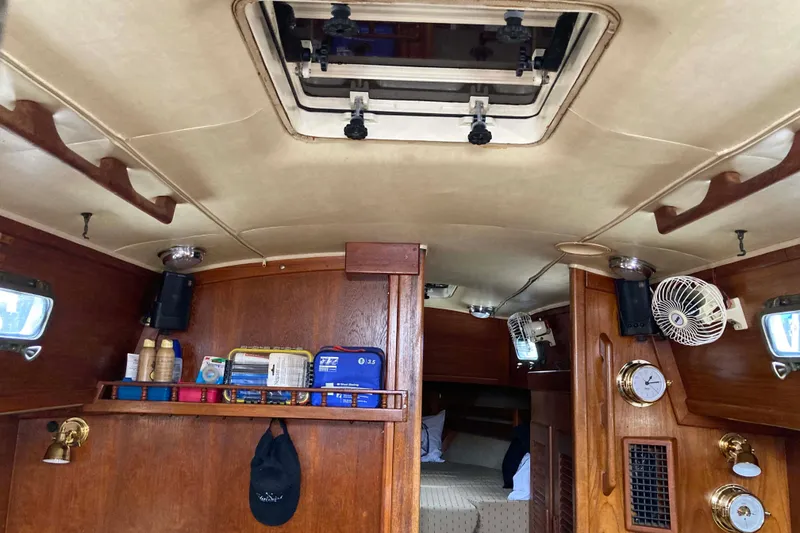 Slide: The Image of Interior of 1990 Pacific Seacraft 34 Voyager sailboat with wooden cabinetry and nautical decor. - 31