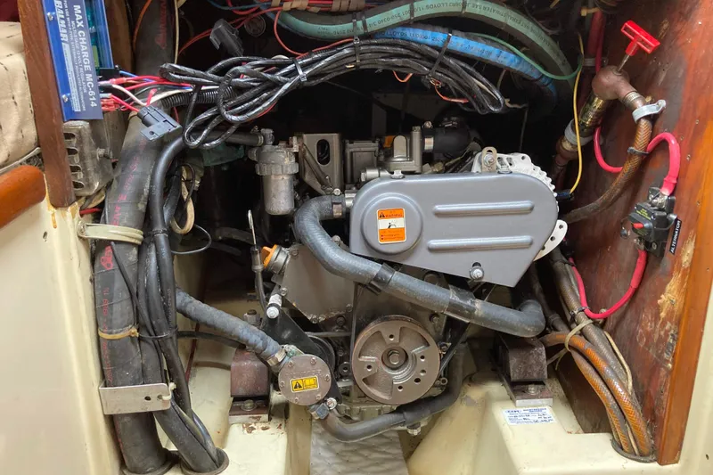 Slide: The Image of Engine compartment of a 1990 Pacific Seacraft 34 Voyager sailboat, showing wiring and components. - 32
