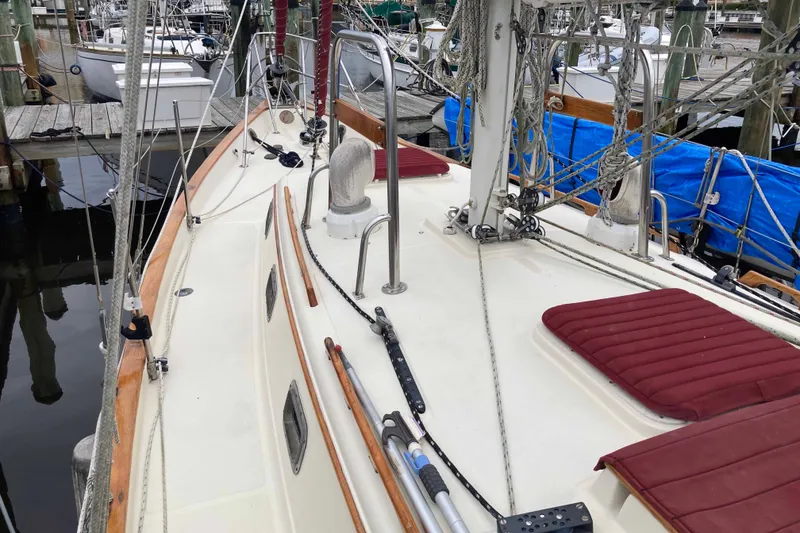 Slide: The Image of 1990 Pacific Seacraft 34 Voyager sailboat deck with red cushions and rigging. - 5