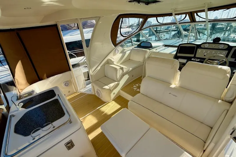 Slide: The Image of 2006 Cruisers Yachts 415 Express Motoryacht interior with luxurious seating and helm. - 10