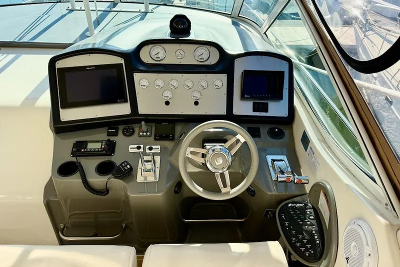 Slide: The Image of 2006 Cruisers Yachts 415 Express Motoryacht helm with modern navigation instruments and controls. - 12