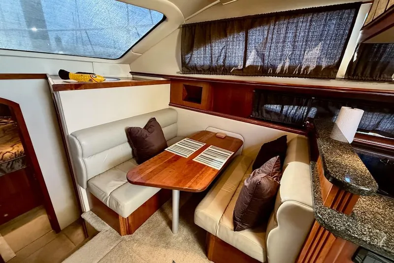 Slide: The Image of Luxurious 2006 Cruisers Yachts 415 Express Motoryacht interior dining area with elegant seating. - 20