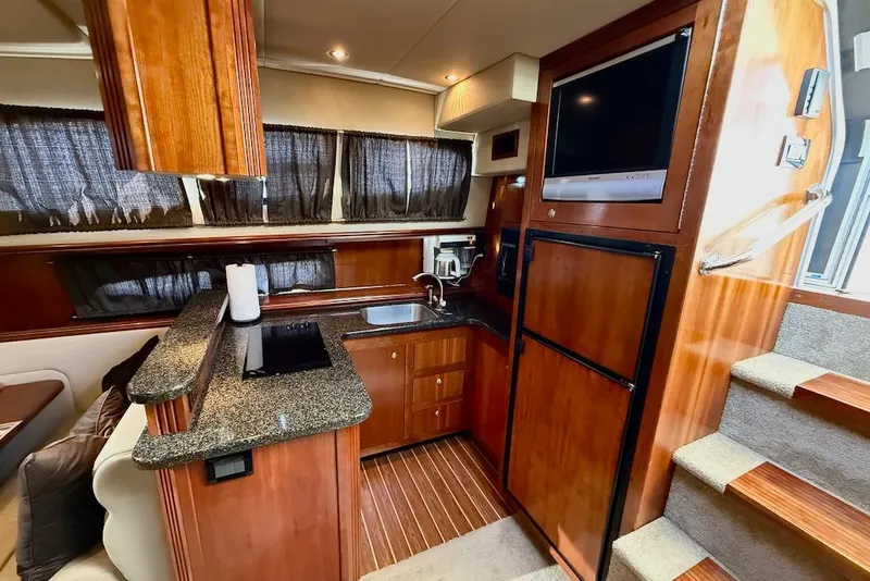 Slide: The Image of Luxurious 2006 Cruisers Yachts 415 Express Motoryacht interior with modern kitchen amenities. - 22