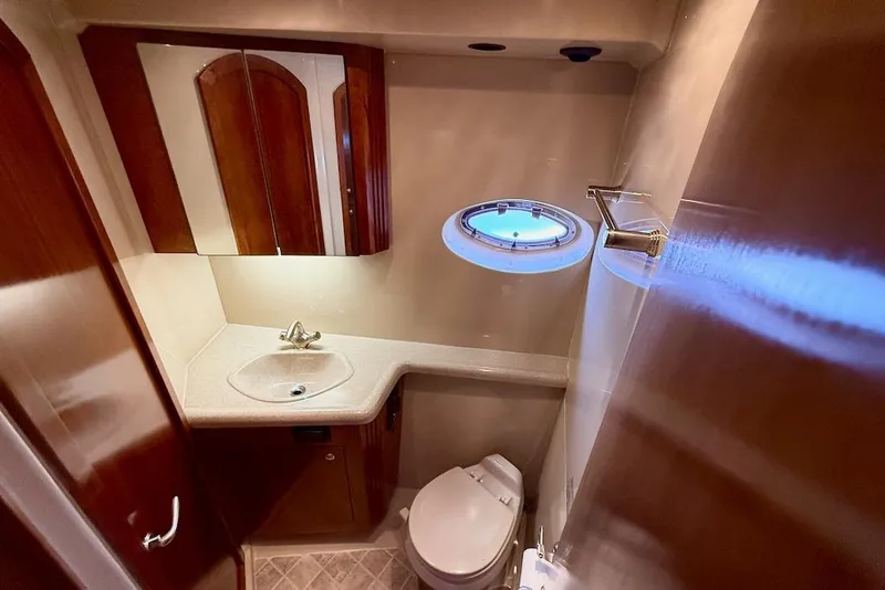 Slide: The Image of Luxurious bathroom in 2006 Cruisers Yachts 415 Express Motoryacht with elegant wood finishes. - 25