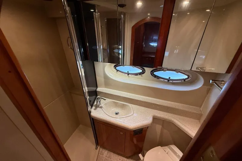 Slide: The Image of Luxurious bathroom in 2006 Cruisers Yachts 415 Express Motoryacht with porthole windows. - 30