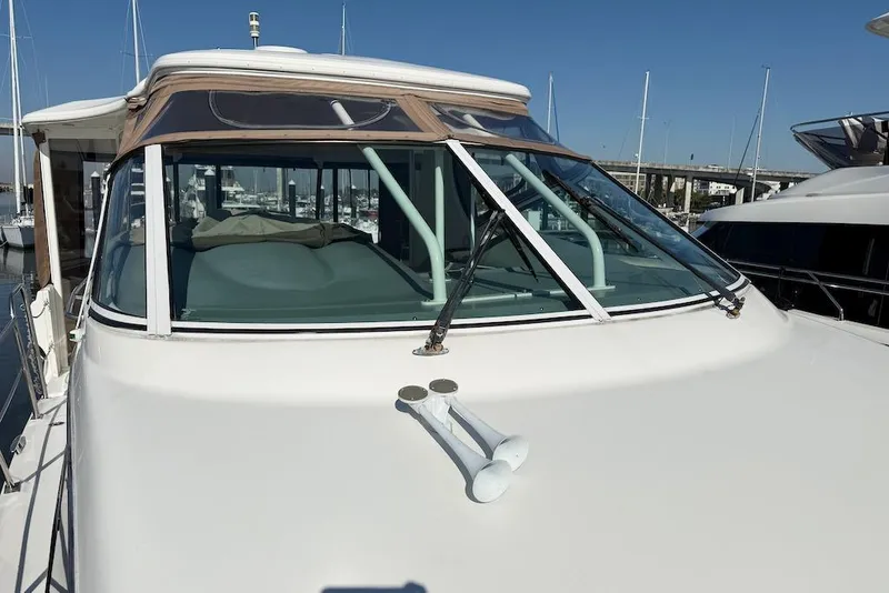 Slide: The Image of 2006 Cruisers Yachts 415 Express Motoryacht docked at marina, front view. - 6