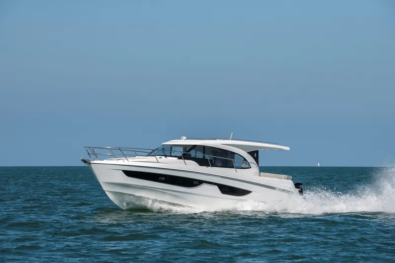 Slide: The Image of 2026 Beneteau Antares 11 Coupe cruising on open sea under clear blue sky. - 2