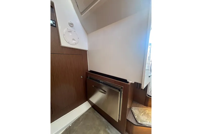 Slide: The Image of Interior view of 2026 Beneteau Antares 11 Coupe, featuring modern cabinetry and stainless steel appliance. - 27