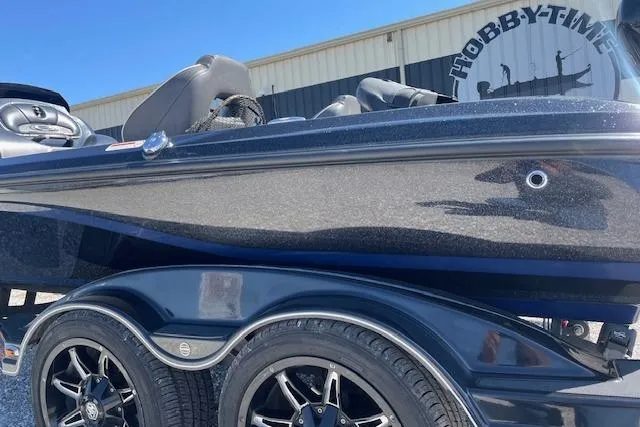 Slide: The Image of 2018 Nitro Z21 boat with sleek design and stylish wheels, parked outside Hobby-Time. - 2